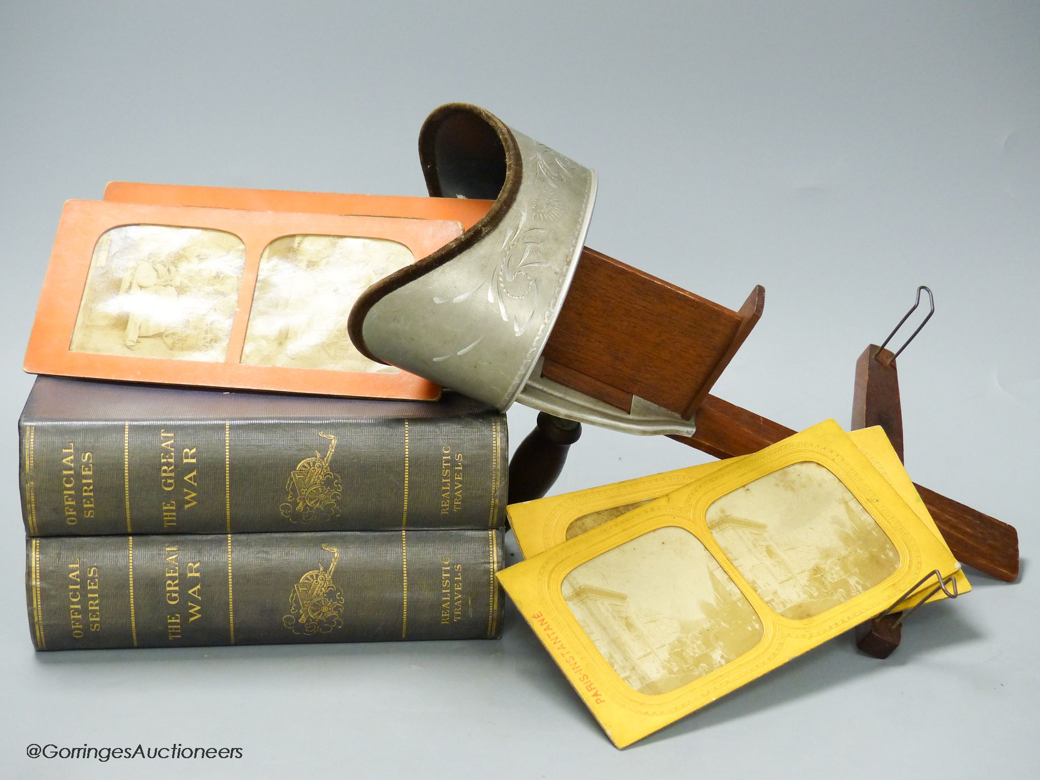 An Underwood & Underwood stereoscopic viewer, a collection of Realistic Travels 'The Great War' slides in book form case and twenty loose slides